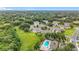 Community aerial view with pool and lush green landscaping and trees around the homes at 2092 Switch Grass Cir, Ocoee, FL 34761