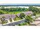 Aerial view of gray townhomes featuring two-car garages, landscaped yards, and lush trees at 2092 Switch Grass Cir, Ocoee, FL 34761