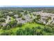 Aerial view of the community features manicured lawns, mature trees and multiple residential buildings at 2092 Switch Grass Cir, Ocoee, FL 34761