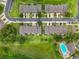 Aerial view of townhome community features landscaping, parking, manicured lawns, and a refreshing community pool at 2092 Switch Grass Cir, Ocoee, FL 34761