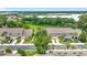 Aerial view of modern townhomes with two car garages, manicured lawns and lush trees at 2092 Switch Grass Cir, Ocoee, FL 34761