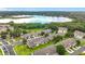 Aerial view of townhomes with community pool and lake views surrounded by lush trees at 2092 Switch Grass Cir, Ocoee, FL 34761
