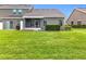 Lush green backyard with a screened-in porch and well-maintained landscaping and lawn at 2092 Switch Grass Cir, Ocoee, FL 34761