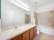 Bathroom with a large vanity, tub and shower combination, and tile accents at 2092 Switch Grass Cir, Ocoee, FL 34761