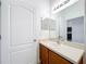 Well-lit bathroom featuring a large mirror, vanity with sink, and a clean, white door at 2092 Switch Grass Cir, Ocoee, FL 34761