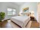 Bedroom with a comfy bed, modern art and wood-style floors at 2092 Switch Grass Cir, Ocoee, FL 34761