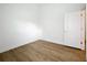 Bedroom featuring neutral walls, wood-look flooring, and a doorway to another room at 2092 Switch Grass Cir, Ocoee, FL 34761
