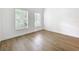 Well-lit bedroom with neutral walls, ample natural light, and wood-look flooring at 2092 Switch Grass Cir, Ocoee, FL 34761