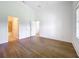 Spacious bedroom with wood floors, neutral paint, and adjacent bathroom and closet at 2092 Switch Grass Cir, Ocoee, FL 34761