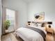 Modern bedroom features a neutral color palette, cozy bed and natural light at 2092 Switch Grass Cir, Ocoee, FL 34761