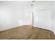 Bedroom featuring neutral walls, wood-look flooring and double-door closet at 2092 Switch Grass Cir, Ocoee, FL 34761