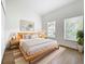 Brightly lit bedroom features hardwood floors, modern decor and a comfortable bed at 2092 Switch Grass Cir, Ocoee, FL 34761