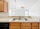 Bright kitchen featuring a stainless steel sink and an open view to the living area at 2092 Switch Grass Cir, Ocoee, FL 34761
