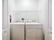 Bright laundry room features a washer, dryer, wire shelving, and a fire extinguisher for added safety at 2092 Switch Grass Cir, Ocoee, FL 34761