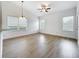 Spacious living room featuring large windows and modern ceiling fan and lighting at 2092 Switch Grass Cir, Ocoee, FL 34761
