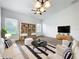 Bright living room boasts hardwood floors, white furniture, and a ceiling fan at 2092 Switch Grass Cir, Ocoee, FL 34761