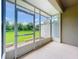 Screened porch with a view of the green yard and partial privacy fence on one side at 2092 Switch Grass Cir, Ocoee, FL 34761