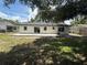 Exterior view of the back of the home, showing the back yard and patio at 212 Dorothy St, Auburndale, FL 33823
