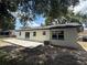 Exterior view of the back of the home, showing the back yard and back patio at 212 Dorothy St, Auburndale, FL 33823