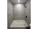 Modern bathroom featuring updated shower with gray tile and modern fixtures at 212 Dorothy St, Auburndale, FL 33823