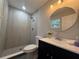 Well-lit bathroom featuring a shower with glass, updated vanity and fixtures at 212 Dorothy St, Auburndale, FL 33823