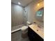 Bathroom featuring a shower with tile surround, updated vanity and fixtures at 212 Dorothy St, Auburndale, FL 33823
