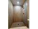 Bathroom featuring a shower with tile surround and modern fixtures at 212 Dorothy St, Auburndale, FL 33823