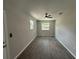 Bedroom showcasing two windows, wood-look tile floors, and a ceiling fan at 212 Dorothy St, Auburndale, FL 33823