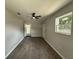 Bright bedroom with neutral walls, ceiling fan, and wood-look tile flooring at 212 Dorothy St, Auburndale, FL 33823