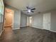 Spacious bedroom featuring neutral walls, wood-look tile floors, and ample closet space at 212 Dorothy St, Auburndale, FL 33823
