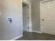 Hallway with doors and grey walls and wood-look tile floors at 212 Dorothy St, Auburndale, FL 33823
