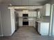Beautiful kitchen featuring stainless steel appliances, white cabinets, and quartz countertops at 212 Dorothy St, Auburndale, FL 33823