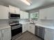 Modern kitchen featuring stainless steel appliances, quartz countertops, and white subway tile backsplash at 212 Dorothy St, Auburndale, FL 33823
