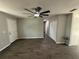 Spacious living room featuring modern floors, neutral walls, updated ceiling fan, and ample natural light at 212 Dorothy St, Auburndale, FL 33823