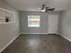 Inviting living room with modern flooring, a built-in display shelf, and a large window for natural light at 212 Dorothy St, Auburndale, FL 33823