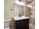Bathroom featuring tiled shower, modern vanity and mirror at 2183 Leather Fern Dr, Ocoee, FL 34761
