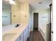 Bathroom features a large mirror above the double sink vanity, with a door leading to the shower and tub at 2183 Leather Fern Dr, Ocoee, FL 34761