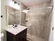Bathroom featuring tiled shower, modern vanity and mirror at 2183 Leather Fern Dr, Ocoee, FL 34761