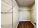 Walk-in closet with metal shelving and hardwood floors at 2183 Leather Fern Dr, Ocoee, FL 34761