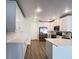 Modern kitchen featuring white cabinets, stainless steel appliances, and a breakfast bar at 2183 Leather Fern Dr, Ocoee, FL 34761