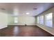 Bright living room featuring hardwood floors, recessed lighting, and large windows at 2183 Leather Fern Dr, Ocoee, FL 34761