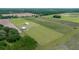 Drone shot showcasing the home, barn, and surrounding acreage at 22212 Sw 210Th Ave, Dunnellon, FL 34431