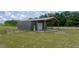 View of the barn with a covered area, complementing the rural setting at 22212 Sw 210Th Ave, Dunnellon, FL 34431