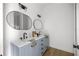 Modern bathroom with double sinks, sleek black fixtures, and decorative oval mirrors at 22212 Sw 210Th Ave, Dunnellon, FL 34431