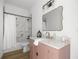 Bathroom with a vanity, white countertops, brushed gold accents, shower with glass door and decorative mirror at 22212 Sw 210Th Ave, Dunnellon, FL 34431