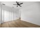 This bright bedroom features a modern ceiling fan, a closet and light wood floors at 22212 Sw 210Th Ave, Dunnellon, FL 34431