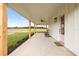 Spacious covered porch with ceiling fans, rocking chairs, and views of the open fields at 22212 Sw 210Th Ave, Dunnellon, FL 34431