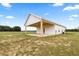 Rear view of a charming home with a covered patio and ample outdoor space at 22212 Sw 210Th Ave, Dunnellon, FL 34431