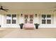 Inviting front porch featuring pink double doors, potted plants, and a charming welcome mat at 22212 Sw 210Th Ave, Dunnellon, FL 34431