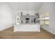 Bright kitchen features white counters, stainless steel appliances, tile backsplash and modern pendant lighting at 22212 Sw 210Th Ave, Dunnellon, FL 34431
